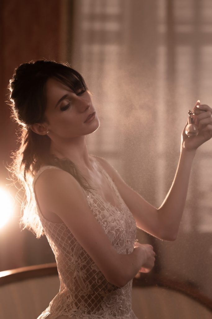 Bride spraying perfume